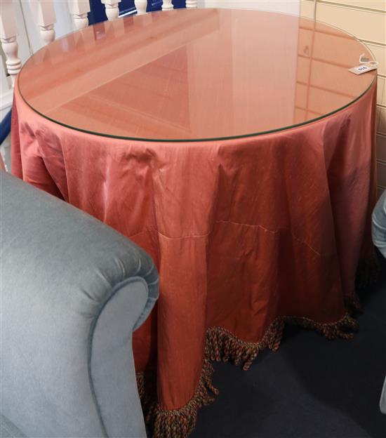 A pair of mahogany circular pedestal tables with silk covers and plate glass tops, 87cm wide